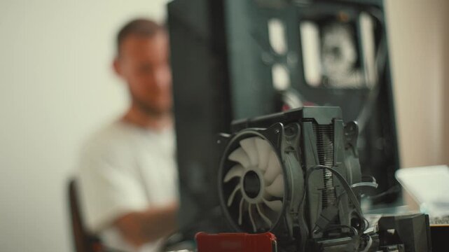 Building a computer at home with a focus on cooling systems and hardware components in a simple workspace environment