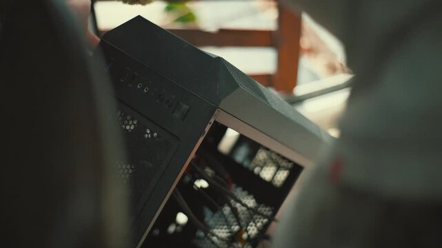 Cleaning a computer case with a brush to remove dust and dirt from inside