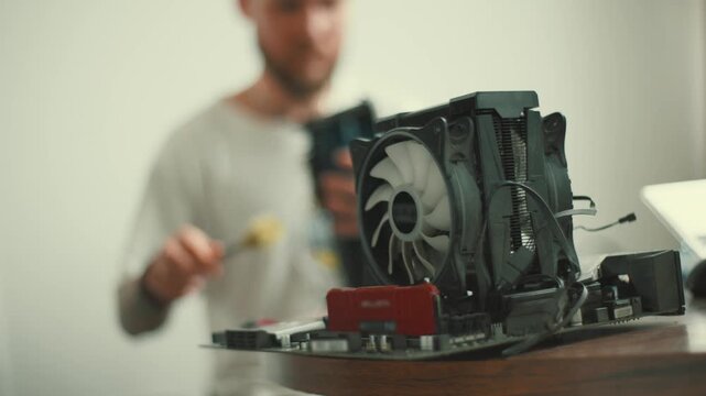 Building a computer setup in a home office with hardware components and tools