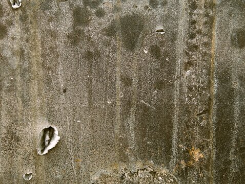 Texture of destroyed APC armor with shell hits and shrapnel holes, damaged armored vehicle hull from modern military conflict, rusty steel surface of knocked out armored personnel carrier, war destruc