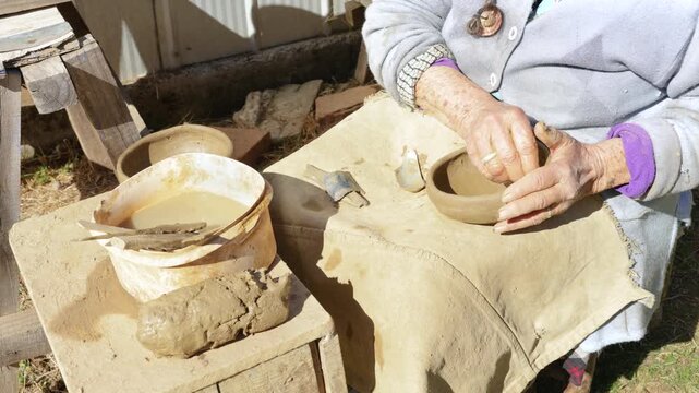  Cauquenes, Chile - March 26, 2026: A 90-year-old artisan works, shaping clay with her hands to create traditional pieces such as bowls, cups, and jugs, keeping a cultural tradition alive.