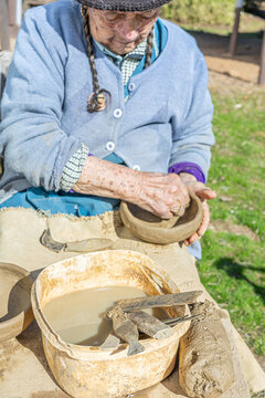  Cauquenes, Chile - March 26, 2026: A 90-year-old artisan works, shaping clay with her hands to create traditional pieces such as bowls, cups, and jugs, keeping a cultural tradition alive.