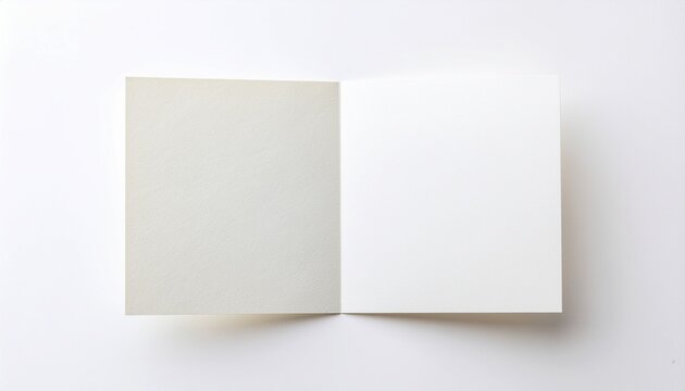 Blank open white greeting card mockup on white background　白背景に置かれた二つ折りの白無地メッセージカード、モックアップ素材