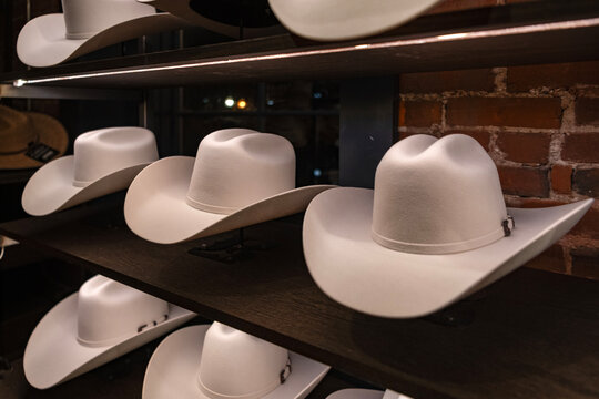 Shopping cowboy hat. Stylish western hat boutique. Choosing western hat. Showcase fashion cowboy male accessories. Fashionable headwear clothes. Fashion headwear store. Hat male fashion shop