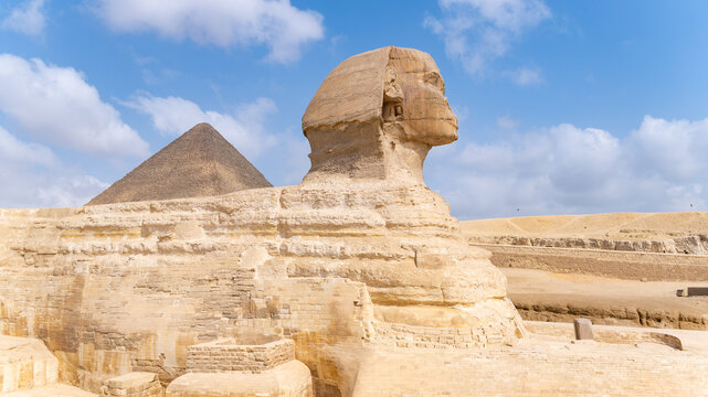 Great sphinx of giza standing guard across desert landscape, ancient limestone structure representing egyptian history and culture