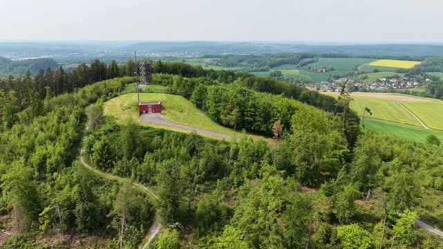 Aerial view of a radio tower on a forested hill