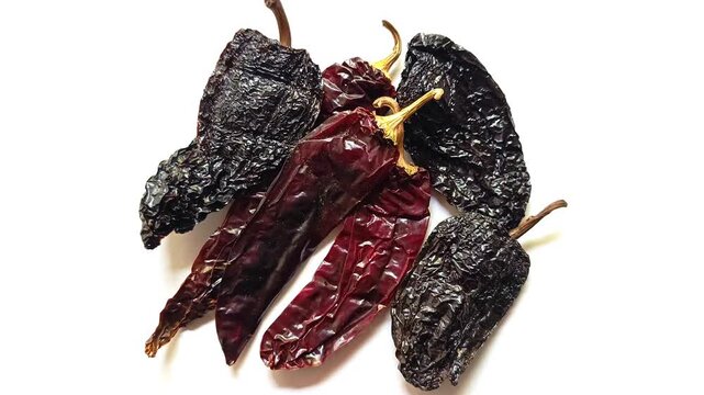 Dried guaque and chile pasa peppers traditional guatemalan ingredients isolated on white background