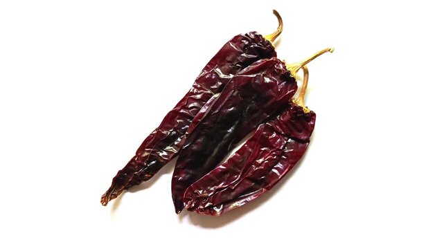 Three dried guaque chili peppers guatemalan traditional spice isolated on white background