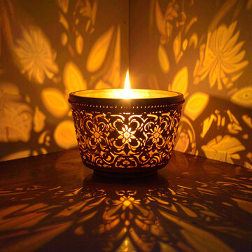 Ornate lantern with candle casting decorative shadows