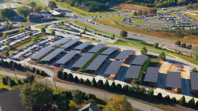 Eco-friendly car parking area covered with photovoltaic panels. Sustainable infrastructure providing both shade for vehicles and renewable energy production.