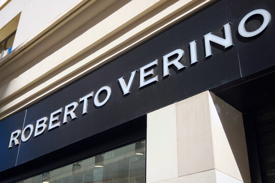 Exterior sign of Roberto Verino clothing store in urban shopping district.