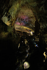 Obraz premium Dramatic limestone cave interior featuring impressive stalactites and stalagmites formed over thousands of years. A fascinating underground landscape showcasing geological heritage, natural wonders, a