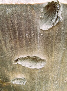 Texture of destroyed APC armor with shell hits and shrapnel holes, damaged armored vehicle hull from modern military conflict, rusty steel surface of knocked out armored personnel carrier, war destruc