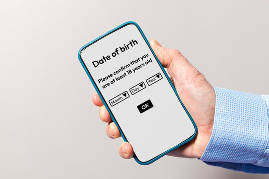 Hand holding smartphone confirming age verification