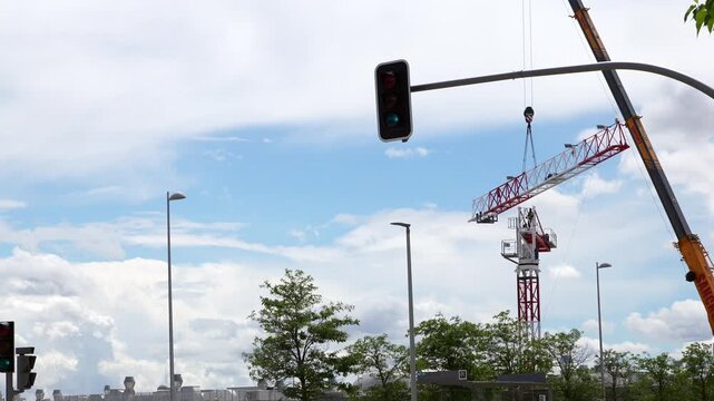 Madrid, Spain - May 12, 2026: Mobile crane lifting a tower crane jib section during construction and urban infrastructure development in Valdebebas district. Editorial.
