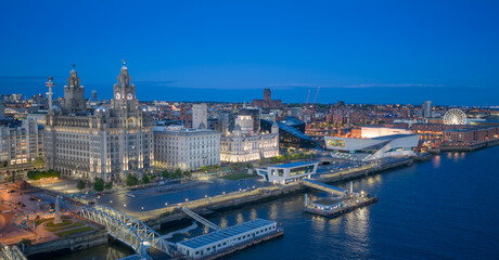 Obraz premium Pier Head Liverpool waterfront with Liver Building and Port of Liverpool offices beside the River Mersey in England.