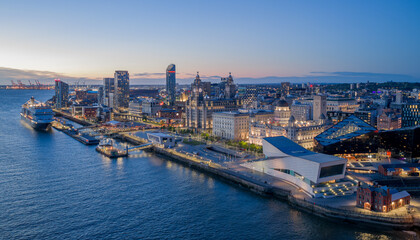 Obraz premium Pier Head Liverpool waterfront with Liver Building and Port of Liverpool offices beside the River Mersey in England.