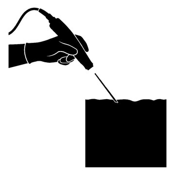 Hand holding electric engraving tool.