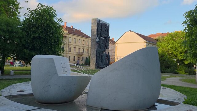 Beautiful fountain and monument at Gledaliski trg in the city center of Celje, Slovenia, 4K