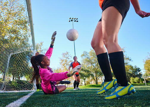 Diverse Group of Women Playing Soccer Together Outdoors