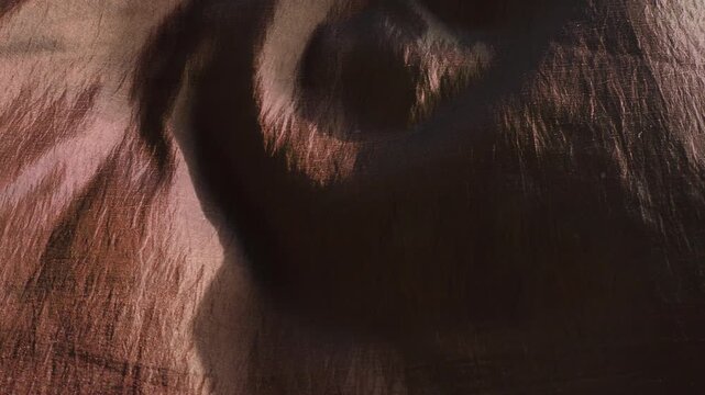 Crinkled brown nylon material close up stock footage.