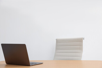 Fototapeta premium Stylish workplace with laptop and chair indoors. Space for text