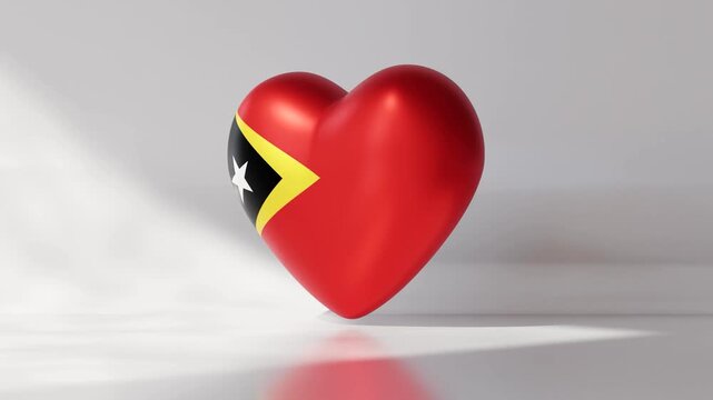 A heart shape spins smoothly while showing the national flag of East Timor. The animation loops seamlessly to display a vibrant representation of national pride