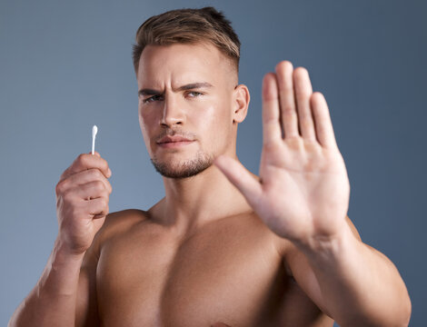 Stop hand, man and cotton bud for ear cleaning, hygiene warning or cosmetics tool danger. Portrait, no or person with earwax removal product, health caution or prevention on gray background in studio
