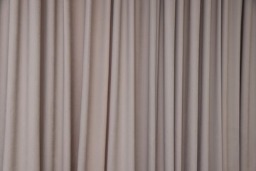 Fototapeta premium Stylish dark beige curtains as background, closeup