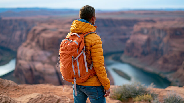 Rear view of a hiker standing at an overlook above the Glen Canyon and Colorado River in Arizona, Glen Canyon overlook concept, Arizona river view photography, canyon and river