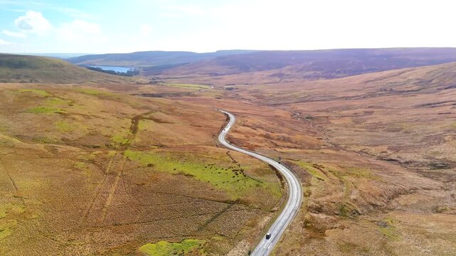 Carter Bar Scotland: 14th March 2026: Drone view of the A68 road winding through Cheviot Hills, on the Anglo-Scottish border on a sunny Springtime day