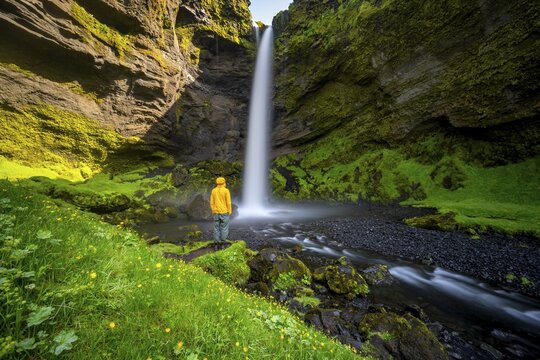 Tourist at Kvernufoss waterfall, in summer when the weather is nice, gorge and river, long exposure, Skogar, Sudurland, South Iceland, Iceland