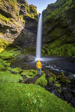 Tourist at Kvernufoss waterfall, in summer when the weather is nice, gorge and river, long exposure, Skogar, Sudurland, South Iceland, Iceland