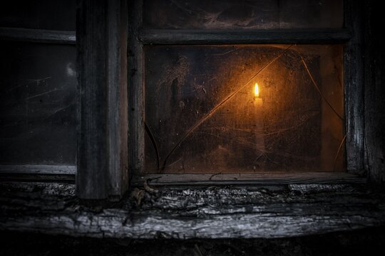 Old decayed wooden window on old house facade in candlelight, Mindelheim, Unterallg&auml;u, Bavaria, Germany
