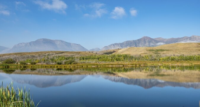Mountains reflected in the lake, Maskinonge Lake, Waterton Lakes National Park, Alberta, Canada
