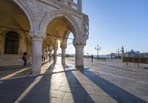 Colonnade of the Doge's Palace with Sun Star in the Piazetta San Marco, St Mark's Square, Venice, Veneto, Italy