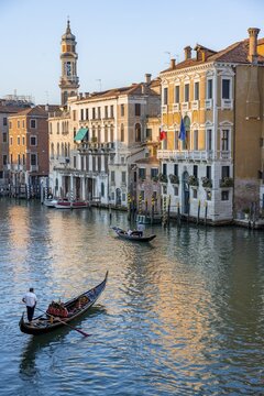 Evening atmosphere on the Grand Canal with gondoliers, view from the Rialto Bridge, Venice, Veneto, Italy