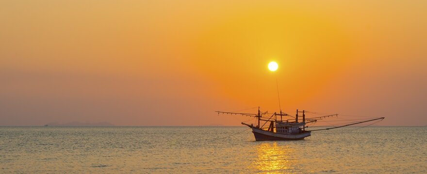Boat in the sea at sunset in front of small islands, Koh Samui, Gulf of Thailand, Thailand
