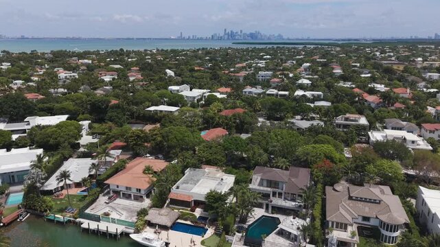 Aerial view of Key Biscayne Luxury Waterfront Paradiase houses, with Miami Downtown in the background