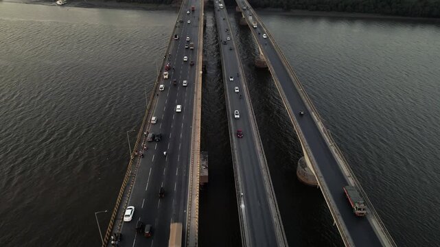 Aerial drone view of the Vasai Creek Bridge in Mumbai, India, spanning across the water and connecting key suburban regions. The scene captures vehicles moving along the bridge.