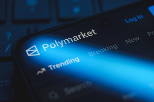 Polymarket website logo and interface displayed on a smartphone screen, decentralized prediction market platform for cryptocurrency betting and political forecasting concept
