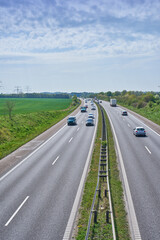 Obraz premium Cars, highway and landscape with scenic view of nature in summer for commute, drive or travel. Background, sky and tourism with vehicles on asphalt road for countryside or rural transportation