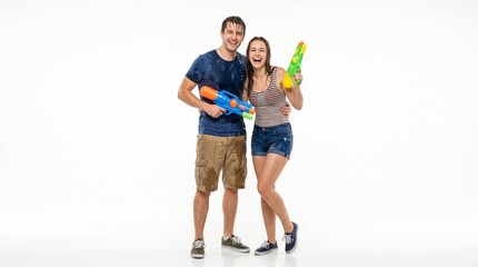 Fototapeta premium Young couple playing with water guns.