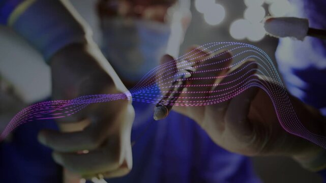 Surgeon holding forceps, cautery treating tissue as animated dotted waveform sweeping across frame