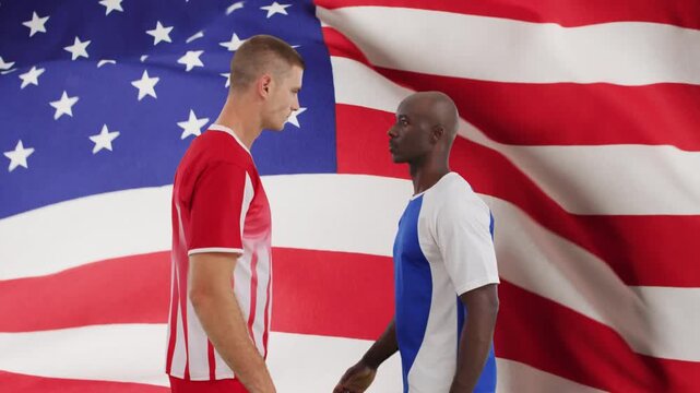 Waving US flag starting two players moving forward closing gap showing rivalry soccer ball crossing