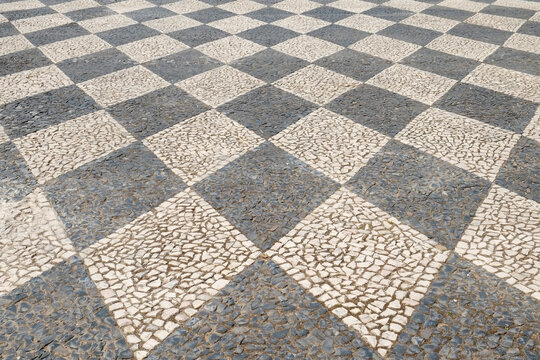 Black and white Portuguese cobblestone pavement pattern