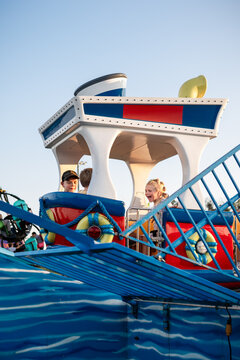 Kids laughing aboard colorful carnival ride