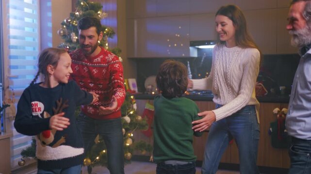 Warmhearted family dancing by decorated tree, Children and elders sharing joy amid holiday decorations and lights