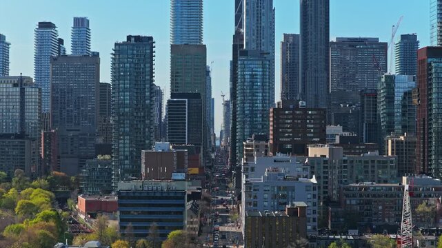 Towering skyscrapers and residential condos defining Toronto's urban canyon along Yonge Street, major transportation artery in Ontario's bustling financial district