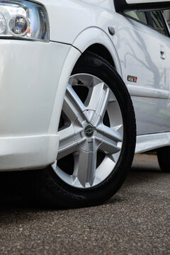 White Chevrolet Astra GSI front wheel close up, Classic hot hatch rim low angle view outdoors